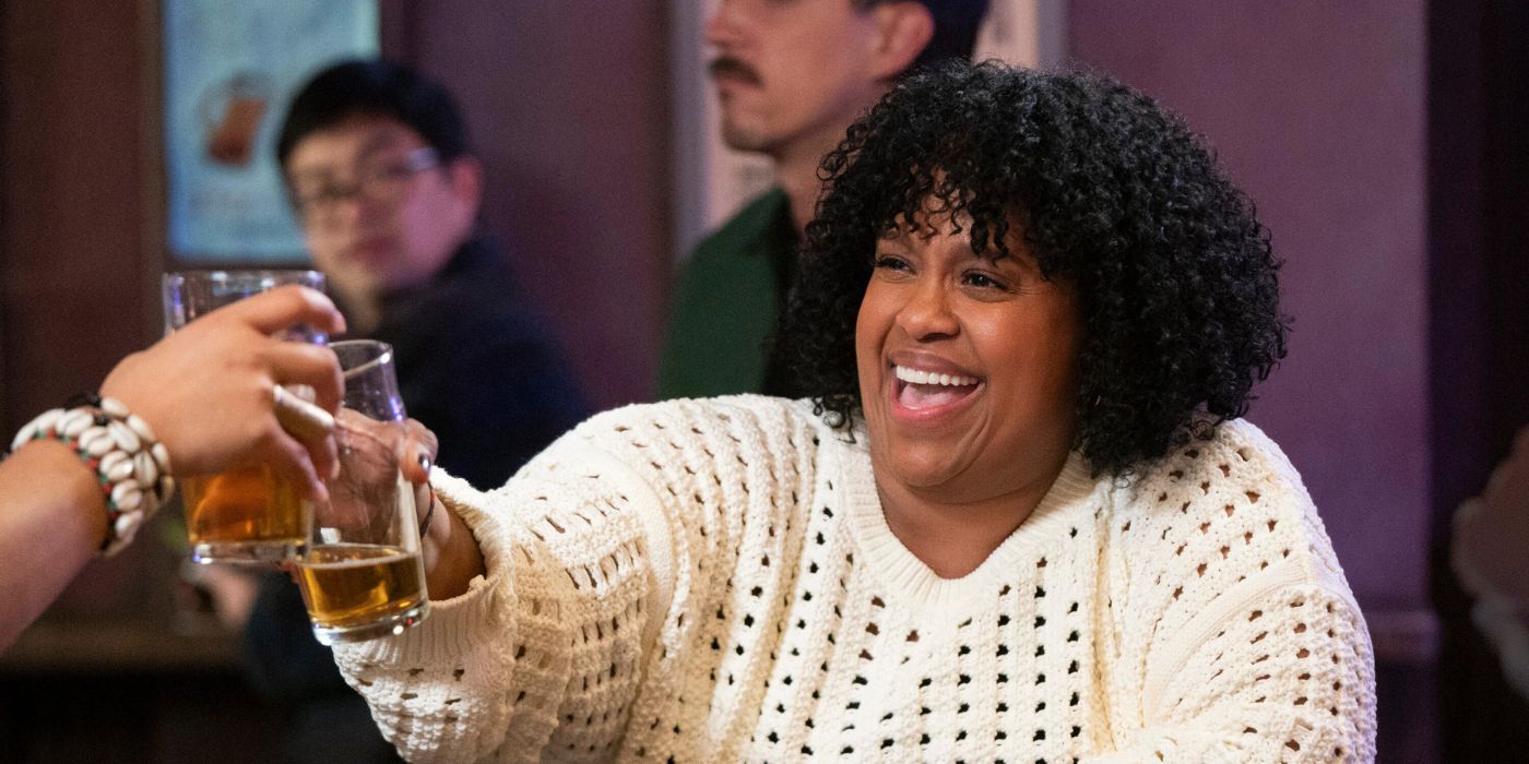 Natasha Rothwell toasting with a beer in How to Die Alone