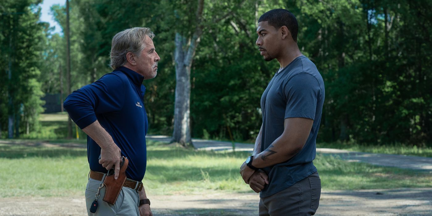 Don Johnson as Chief Sandy Burnne drawing his gun from his belt while facing Aaron Pierre in Rebel Ridge.