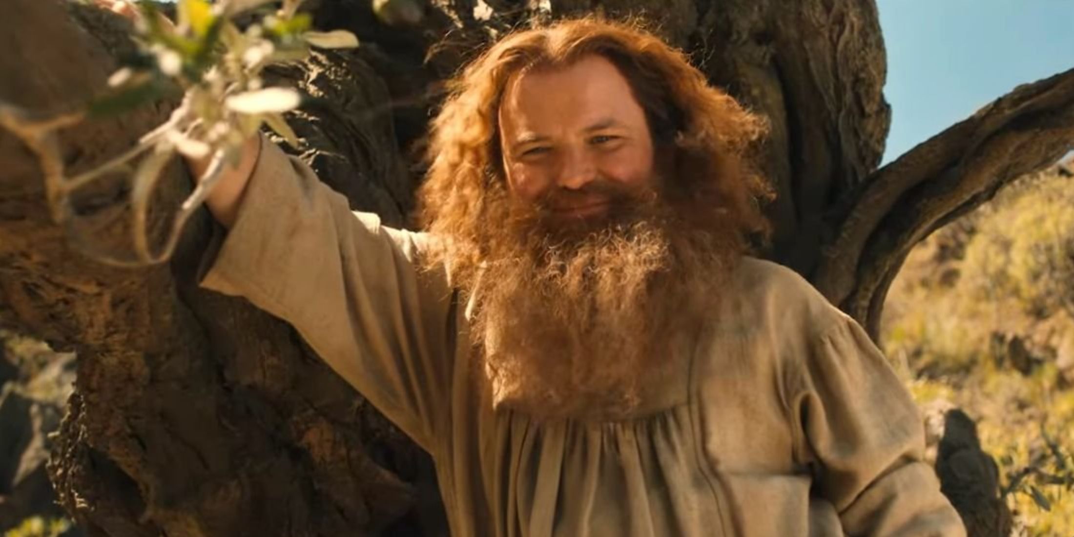 Rory Kinnear as Tom Bombadil smiling in Rings of Power Season 2