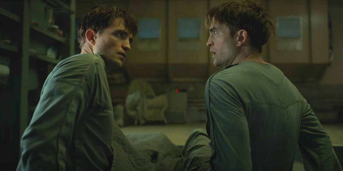 Robert Pattinson as two Mickey clones lying on a bed looking shocked to see each other.