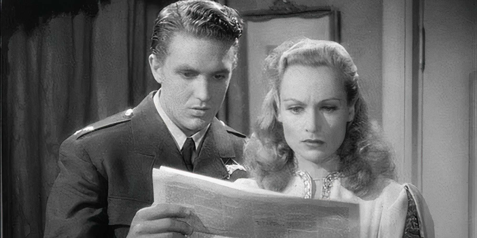 Robert Stack and Carole Lombard looking at a newspaper in To Be or Not to Be (1942)