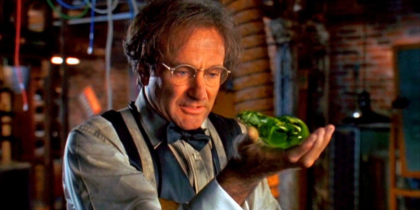 A scientist with soot-covered clothes hols his green gel-like creation called Flubber