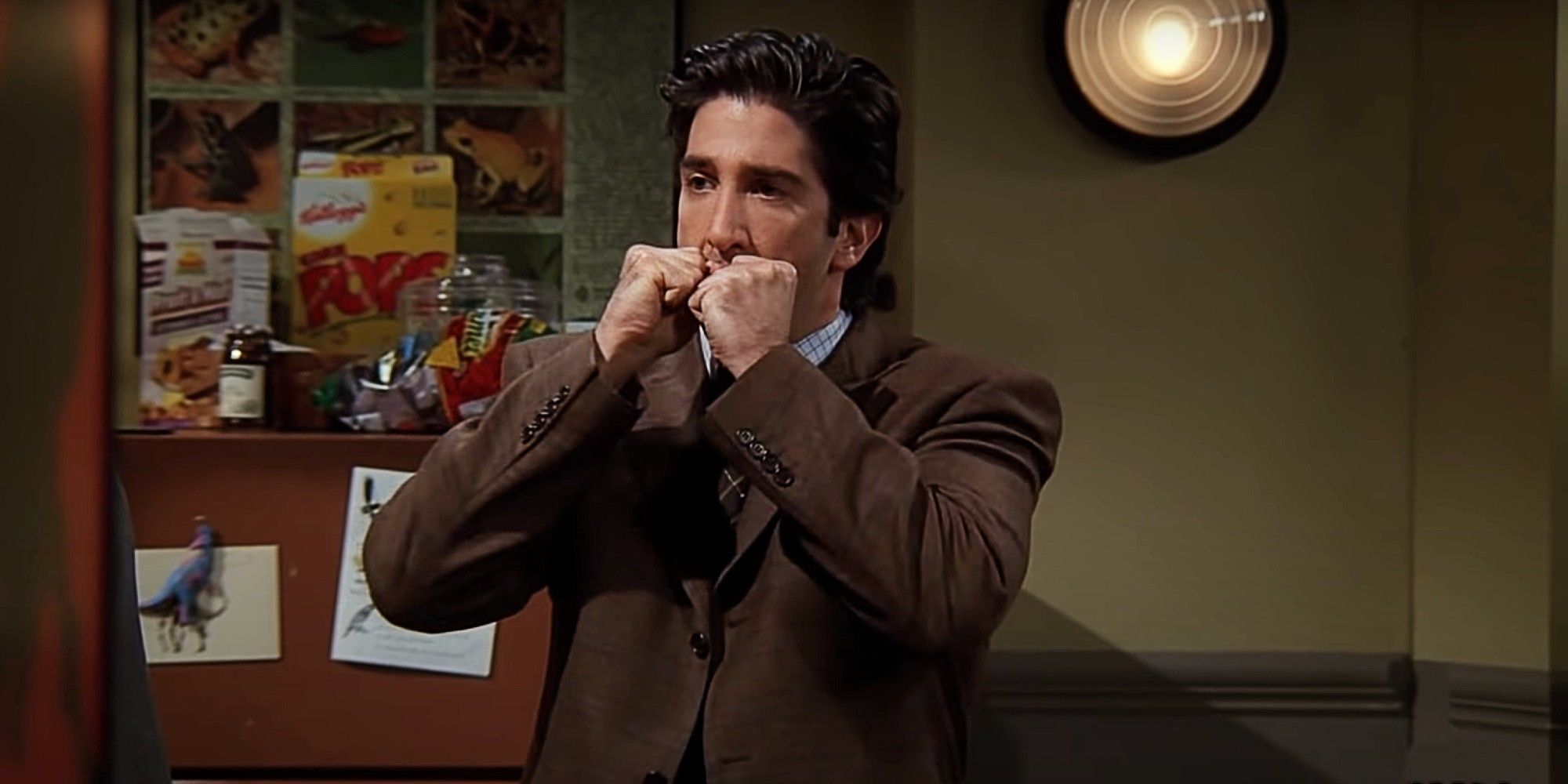 Ross Geller looking angry in Friends with his fists over his mouth