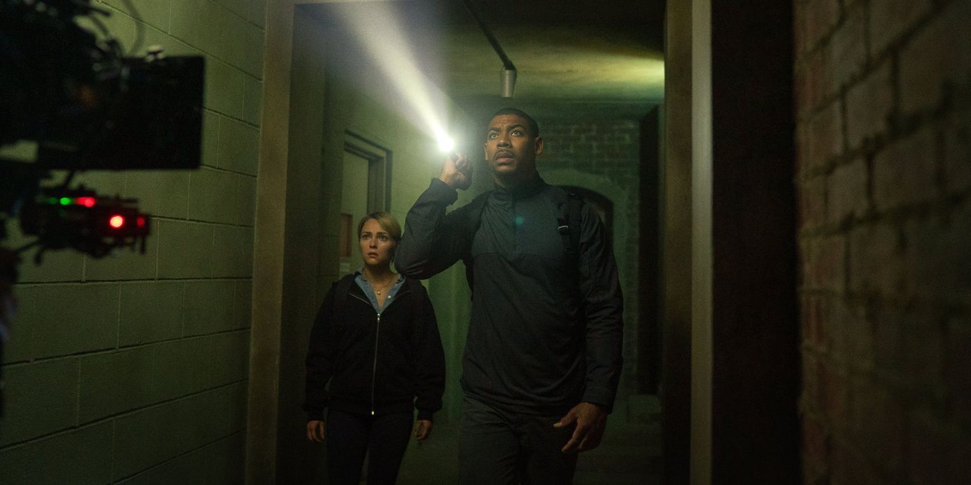 AnnaSophia Robb and Aaron Pierre walking down a dark hallway in Rebel Ridge.