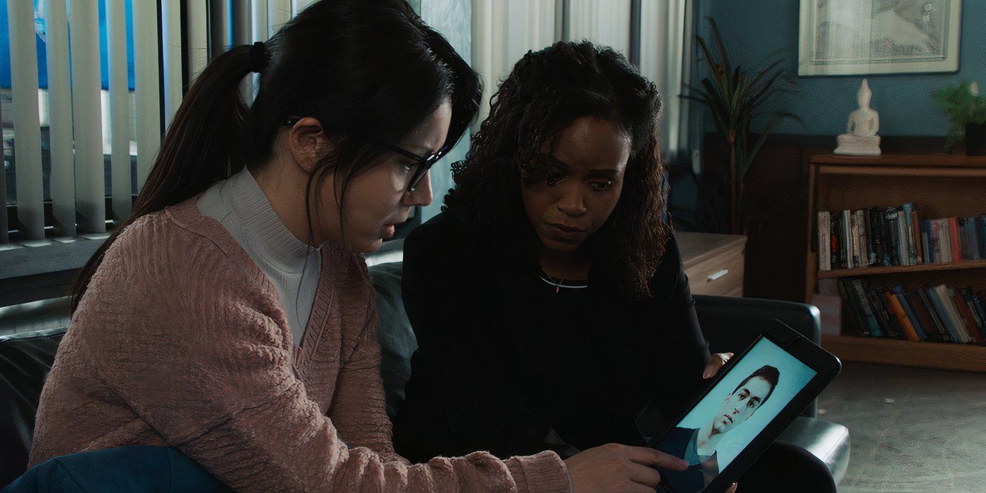 Anastasia Lin as Leah Tan looking at suspects' photos with Aimé Donna Kelly as Captain Renée Curry in Law &amp; Order: SVU.