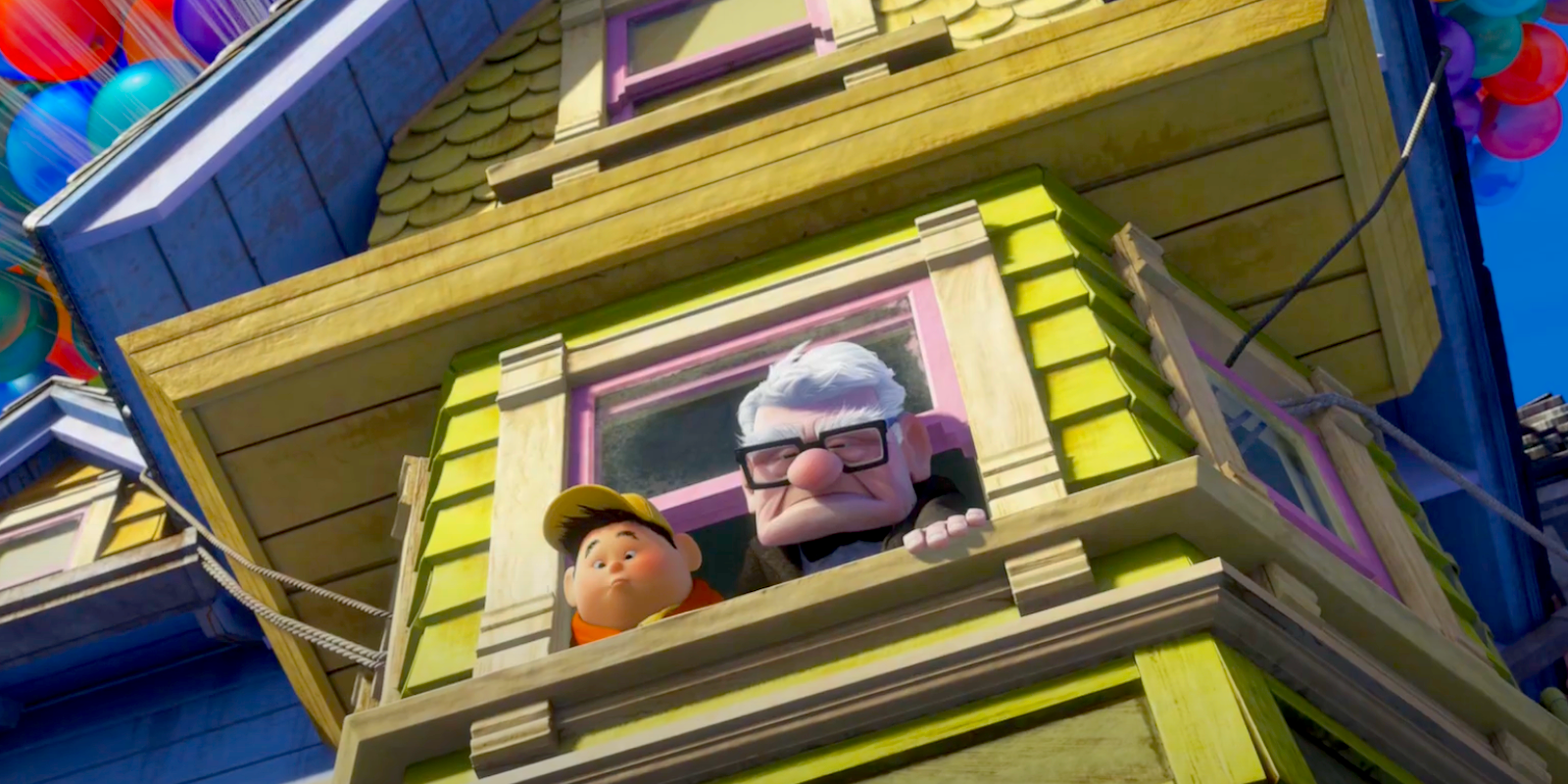 Carl Fredricksen and Russell stare down from the window, the house starting to fly