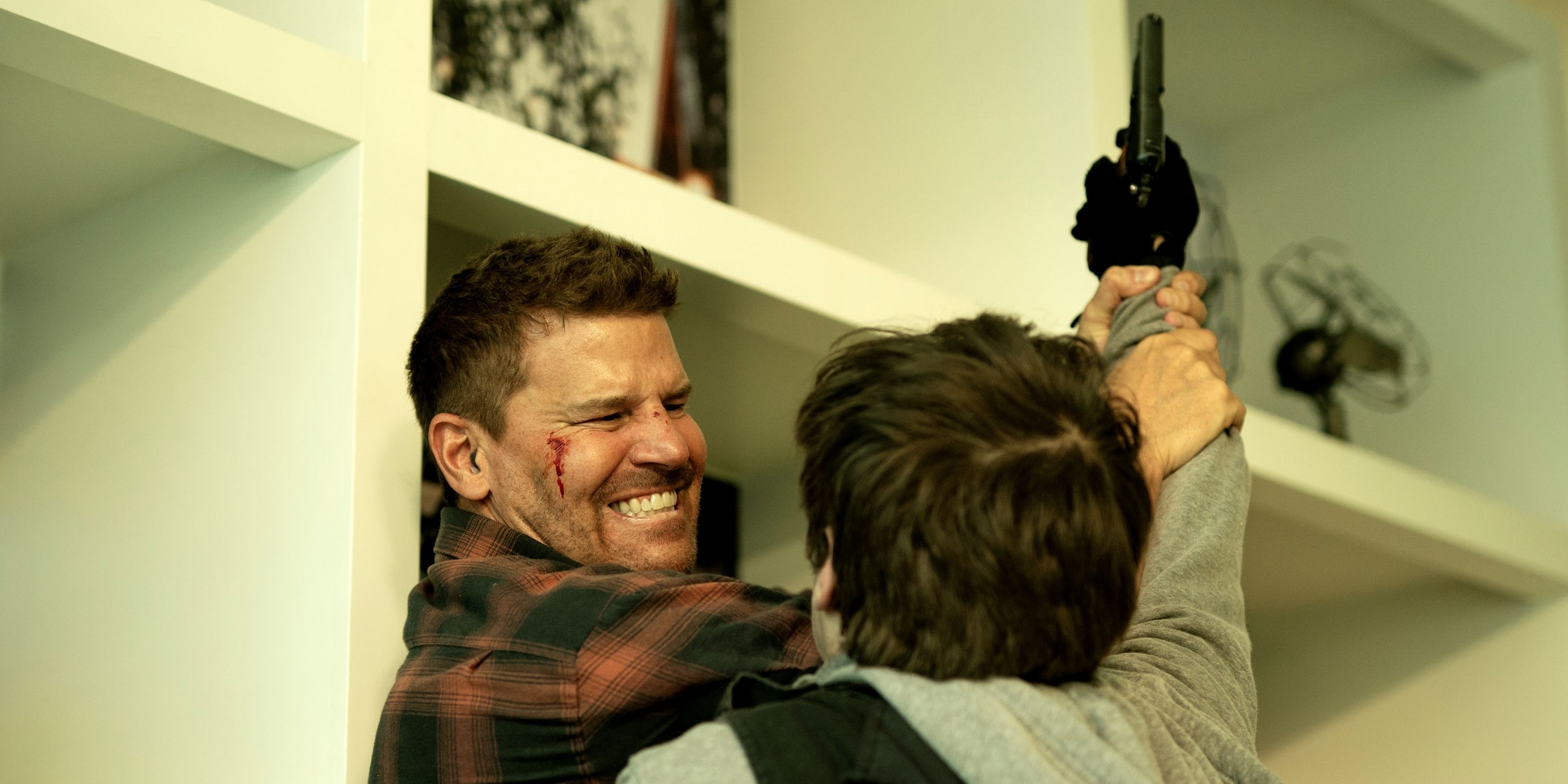 David Boreanaz as Jason Hayes fighting off a bad guy with a gun in Season 7 of SEAL Team