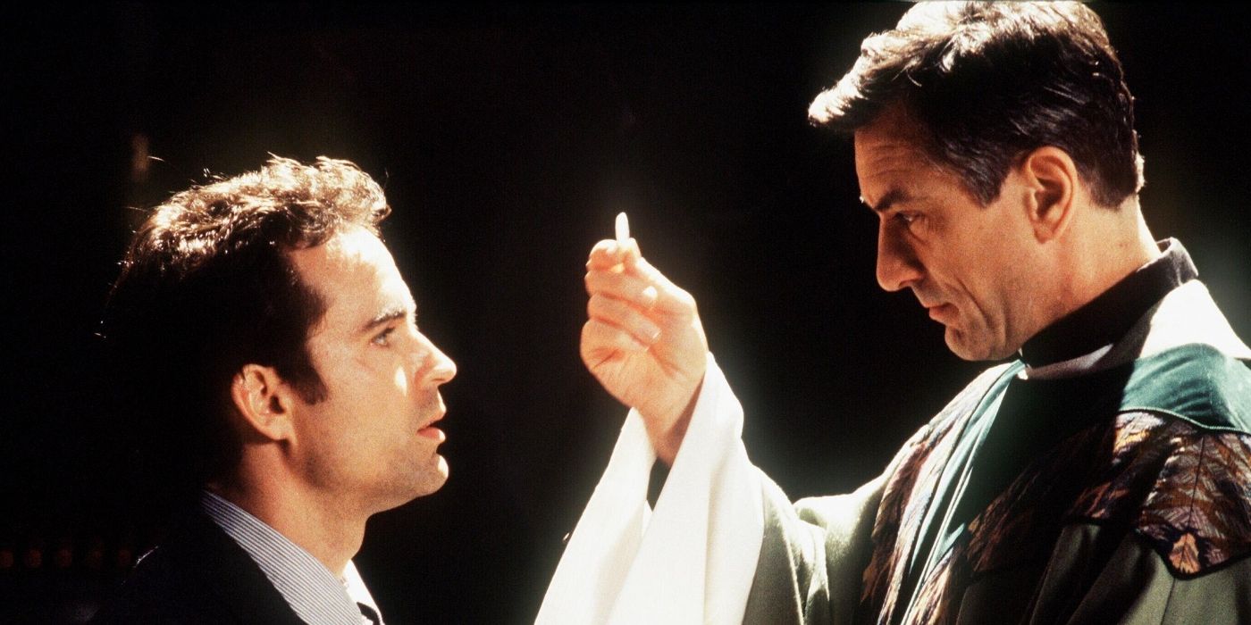 Robert De Niro as Father Bobby giving communion to Jason Patric as Lorenzo 'Shakes' Carcaterra