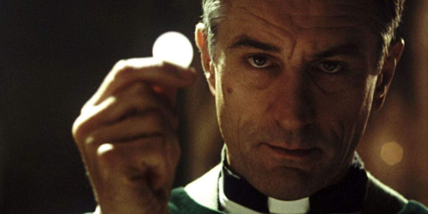 Robert De Niro as Father Bobby Carillo with a quarter in &lsquo;Sleepers&rsquo; (1996)