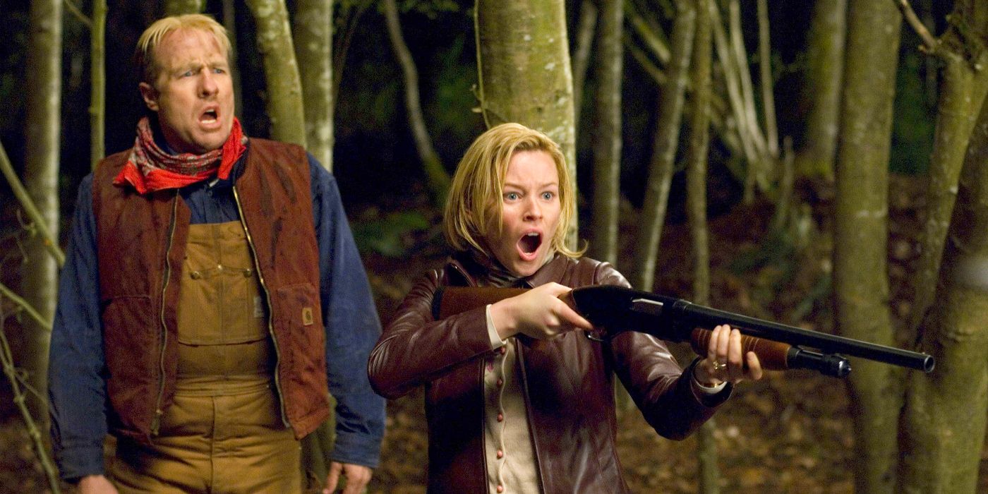 Elizabeth Banks aiming a shotgun toward something offscreen on the right as she stares with an open mouthed expression of horror in Slither