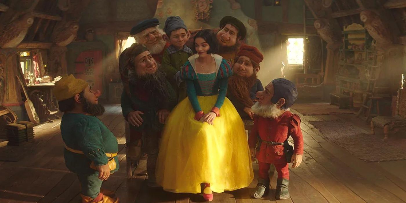 Rachel Zegler as Snow White surrounded by the seven dwarfs.