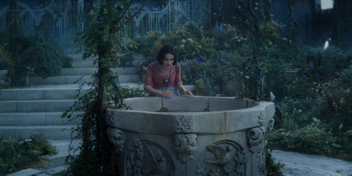 Rachel Zegler as Snow White, looking down a castle well.