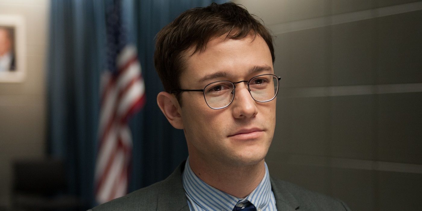 Edward Snowden looking straight ahead, a U.S. flag behind him, in Snowden