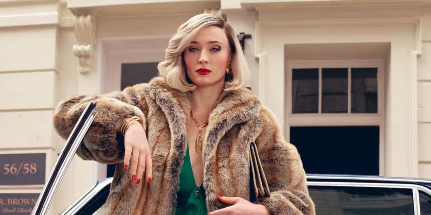 Sophie Turner with her arm on top of a car door, posing with a fur coat and red lips in 'Joan' series.