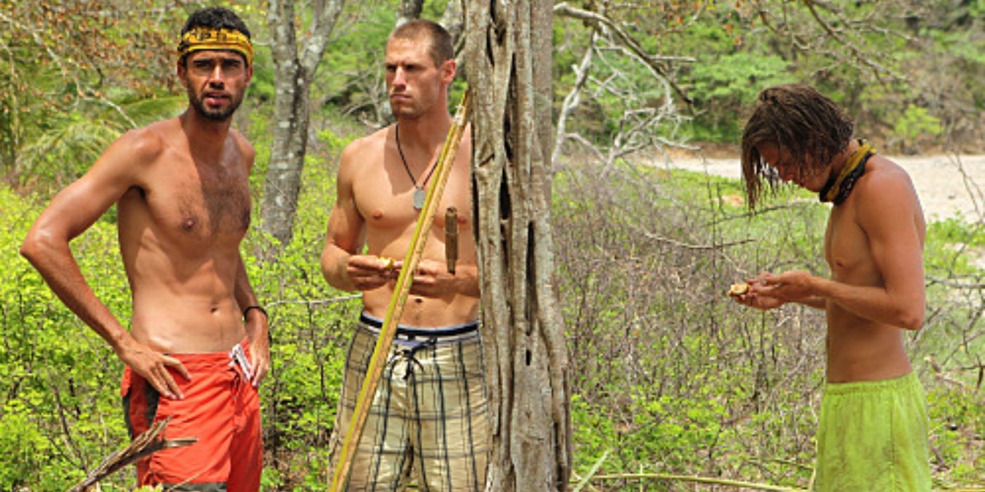 The final three contestants stand in a wooded area near water on Survivor: Nicaragua.