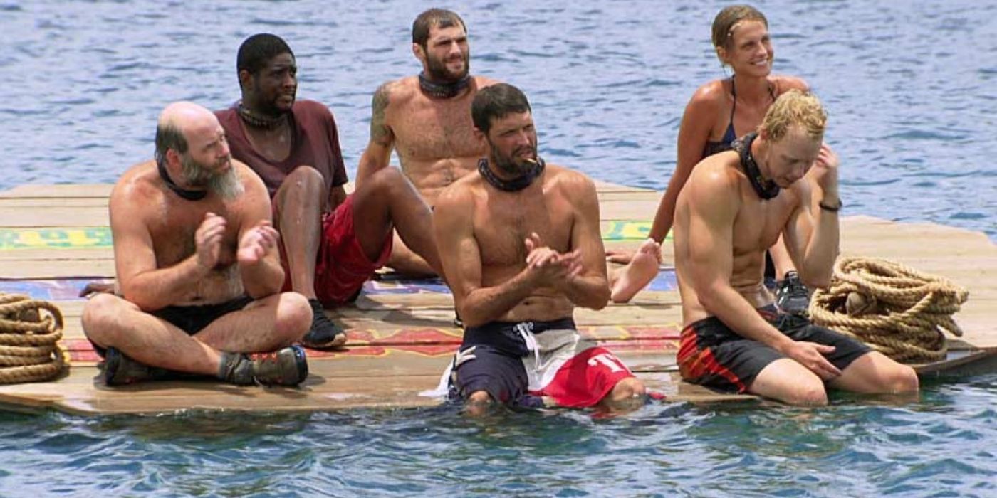 Contestants wait on a floating raft surrounded by water on Survivor: Worlds Apart.