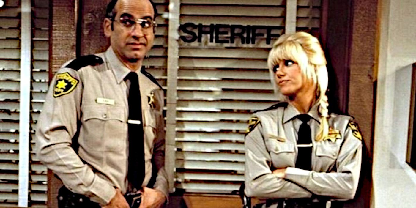 Hildy (Suzanne Somers) stands with her arms crossed next to her deputy in She's the Sheriff.