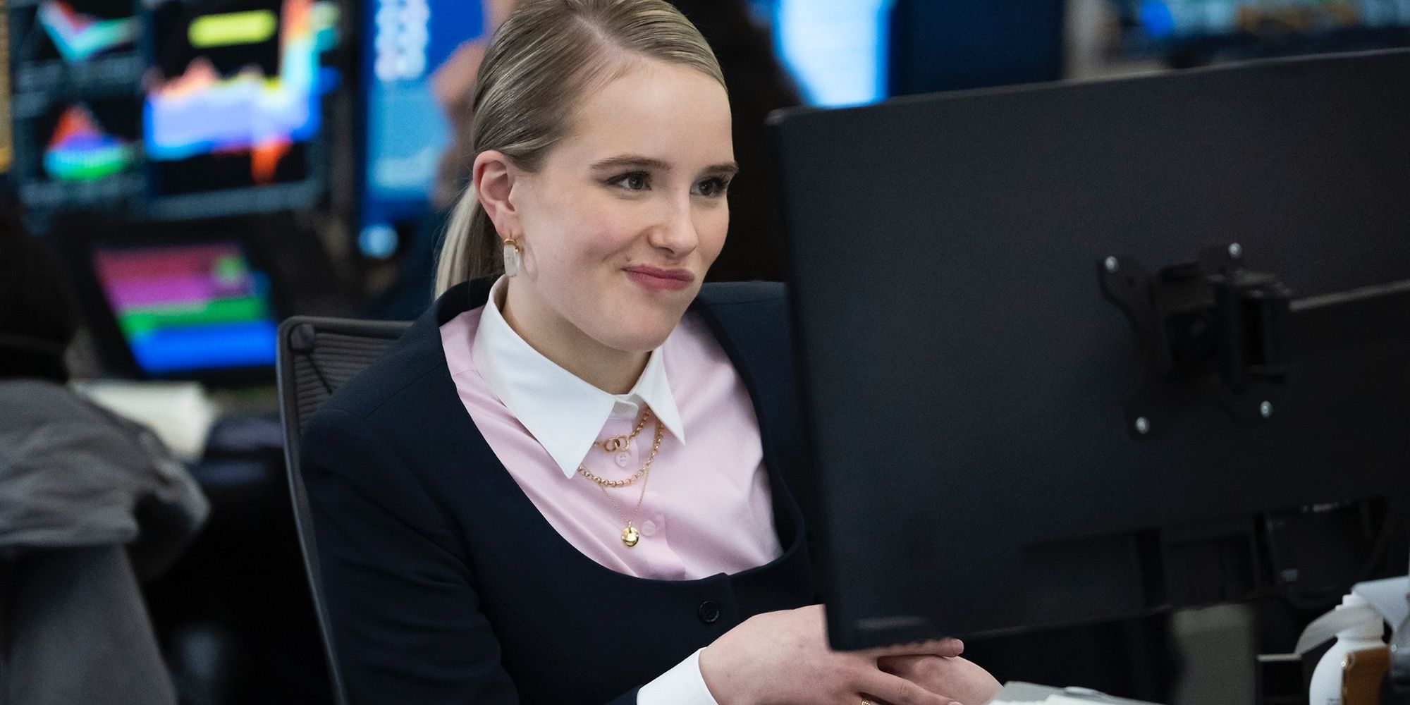 Sweetpea Golightly (Miriam Petche) smirking while looking at a computer in Industry Season 3. 