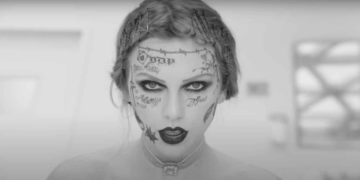 Taylor Swift, in her music video for "Fortnight", with tattoos on her face looks at the camera