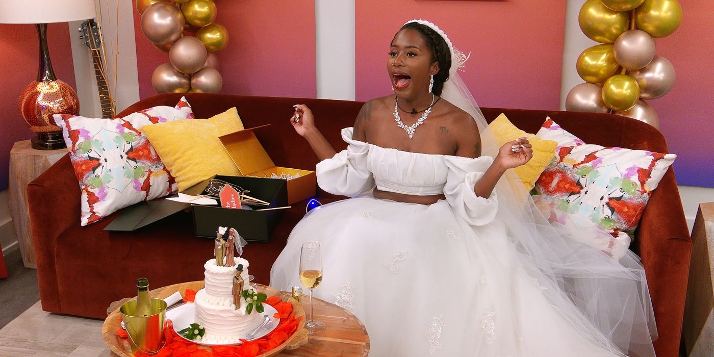 Jadejha Edwards cheers in a wedding dress while sitting on a couch on 'The Circle'