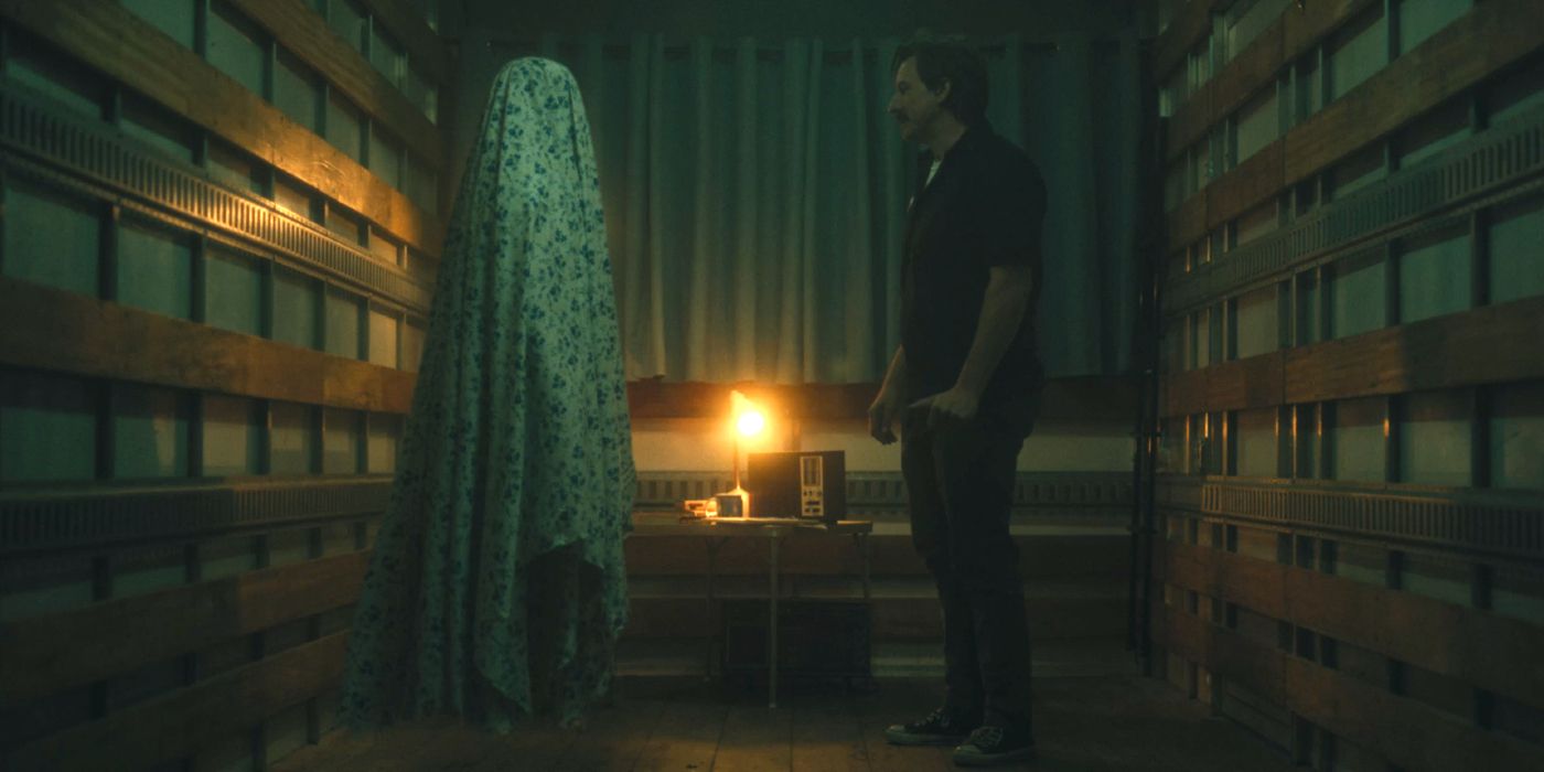 Luke Barnett staring at a blanket ghost in The Crossing Over Express