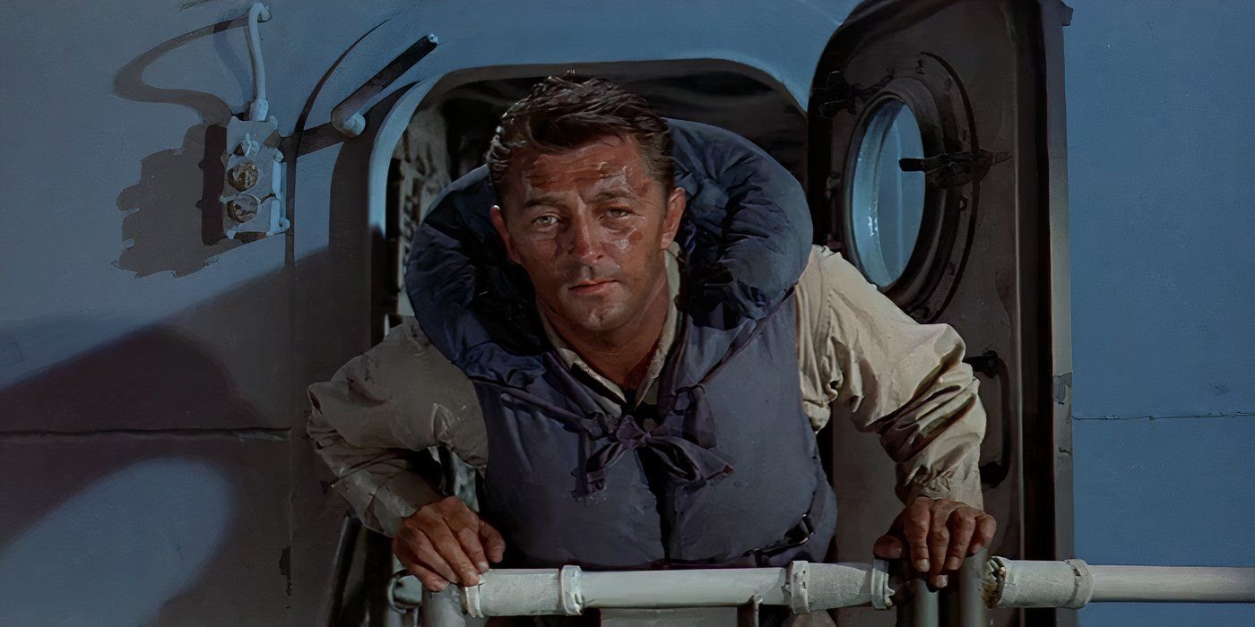 A man in a life jacket looking outside a boat window in The Enemy Below