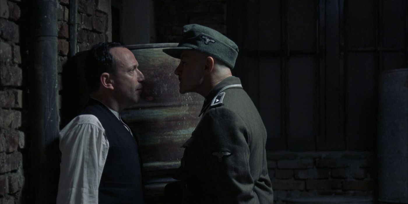 A military officer confronts a man backed up against a brick wall in The Grey Zone.