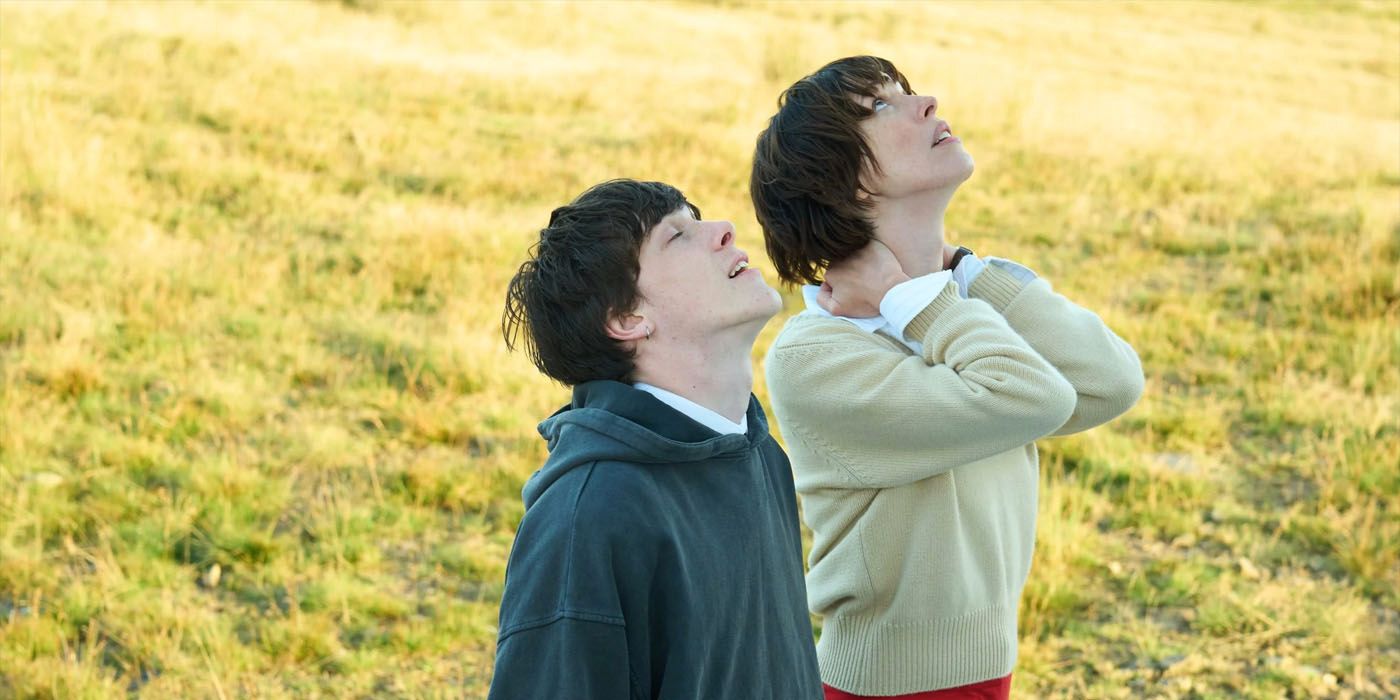 Rebecca Hall and Ollie West look to the sky in a scene from The Listeners