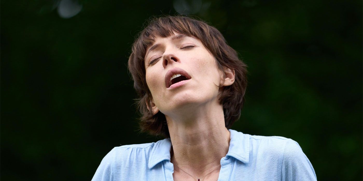 Rebecca Hall is stunned and listening to a hum in a scene from The Listeners