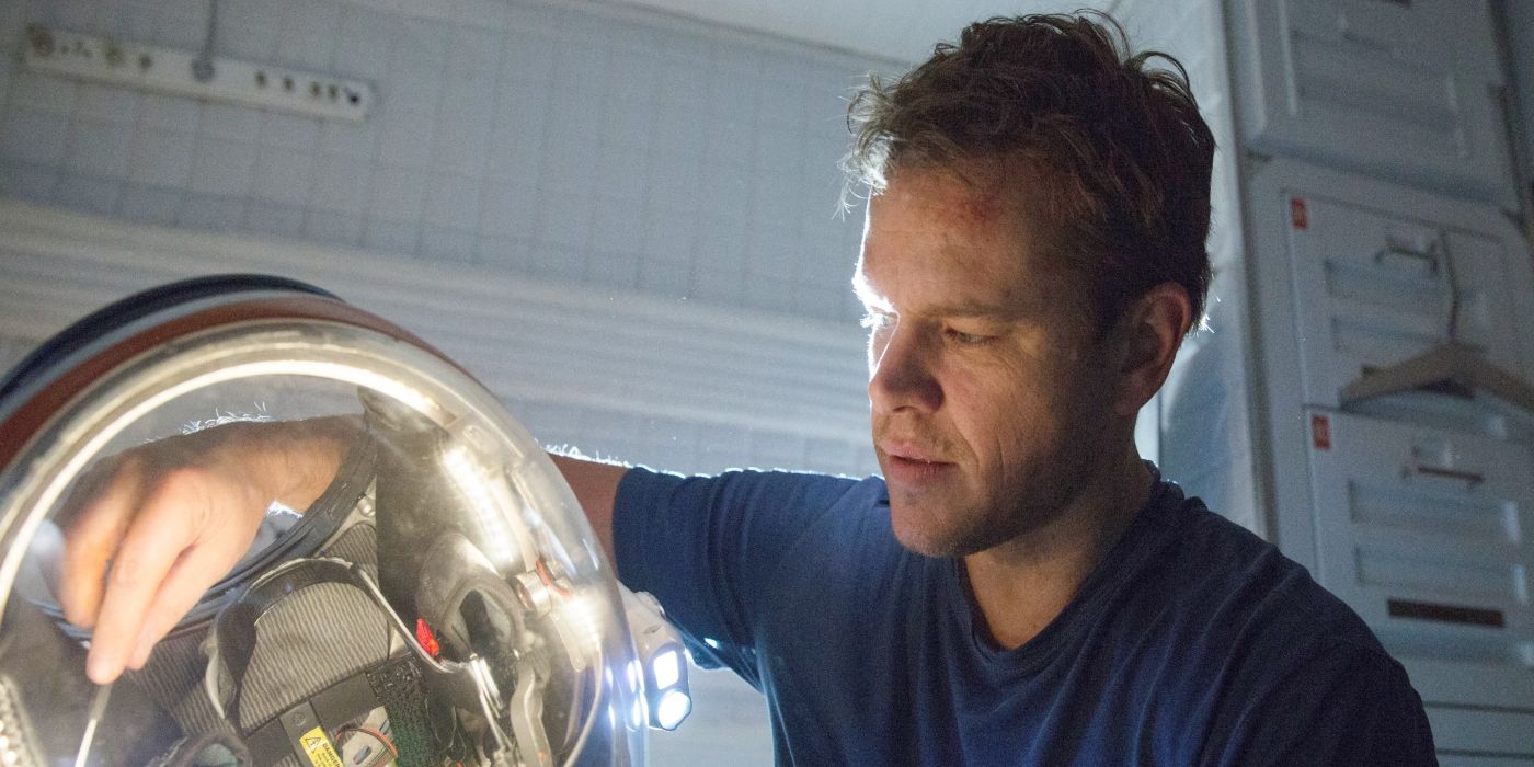 Matt Damon as Mark Watney fixing his helmet in The Martian