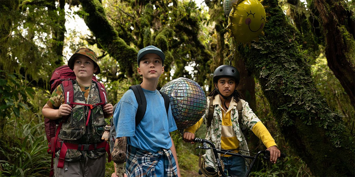 Reuben Francis, Elizabeth Atkinson, and Terence Daniel in the woods with camping gear