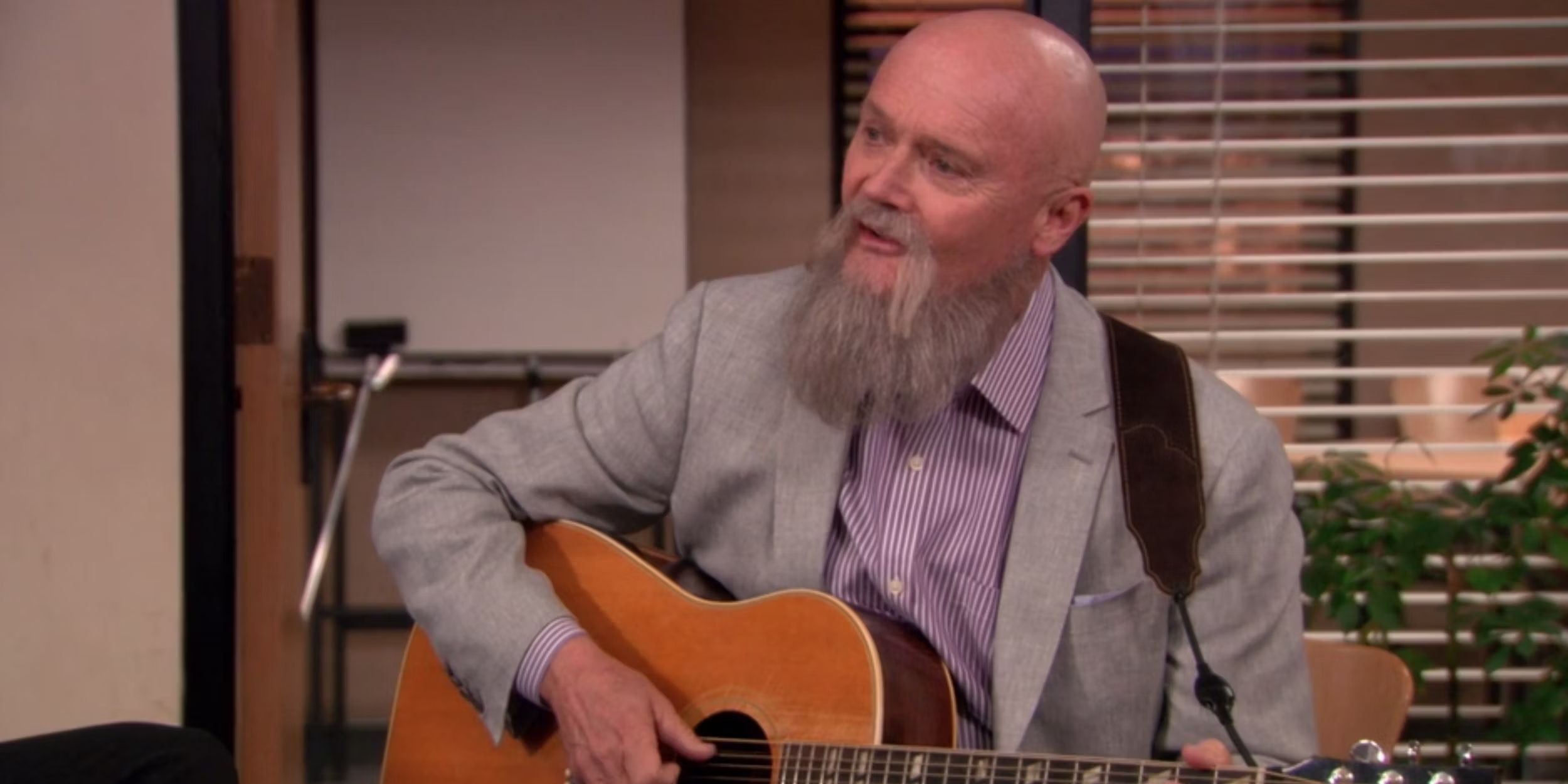 Creed (Creed Bratton) playing guitar in The Office finale