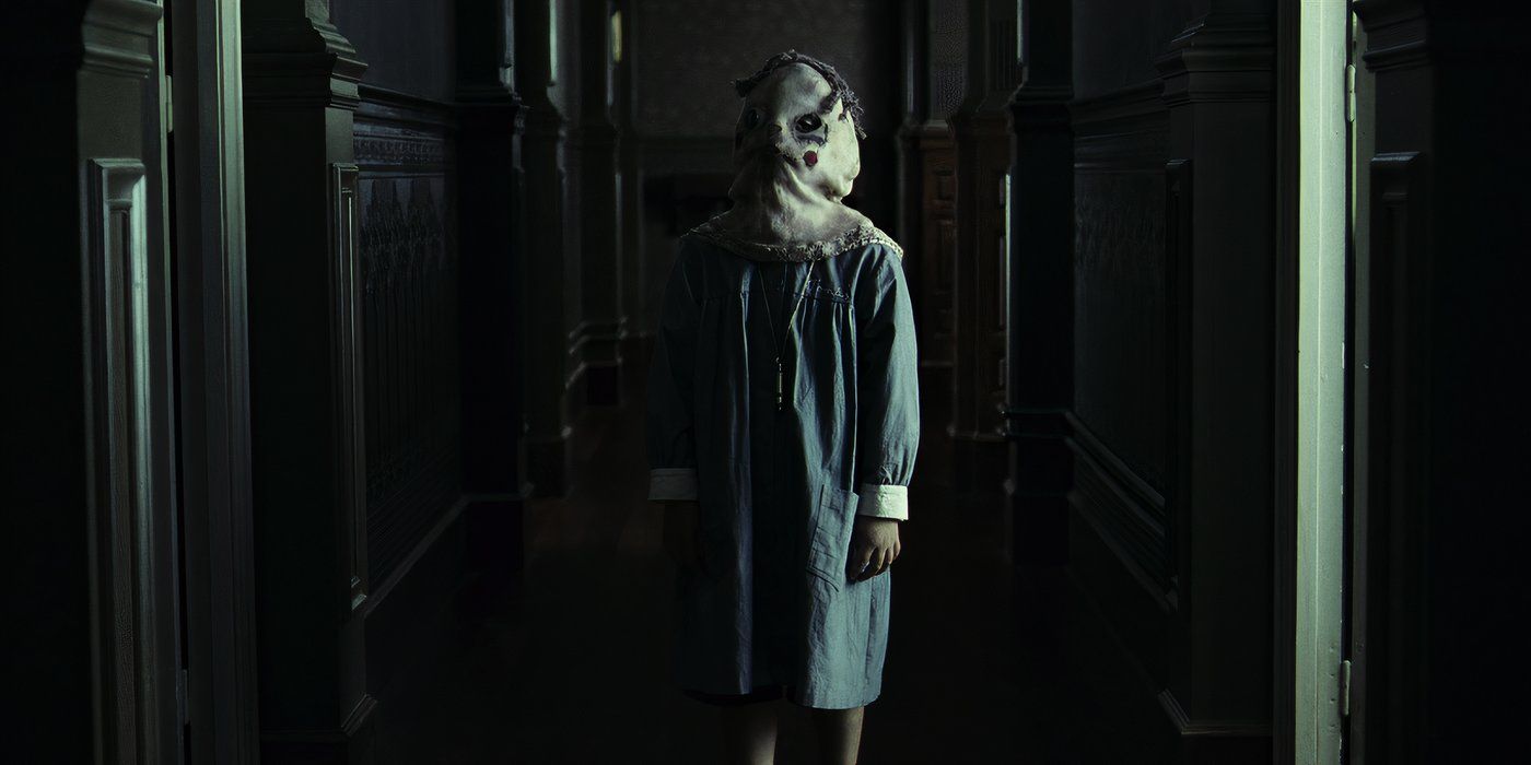 A young man with a bag as a mask in 'The Orphanage'