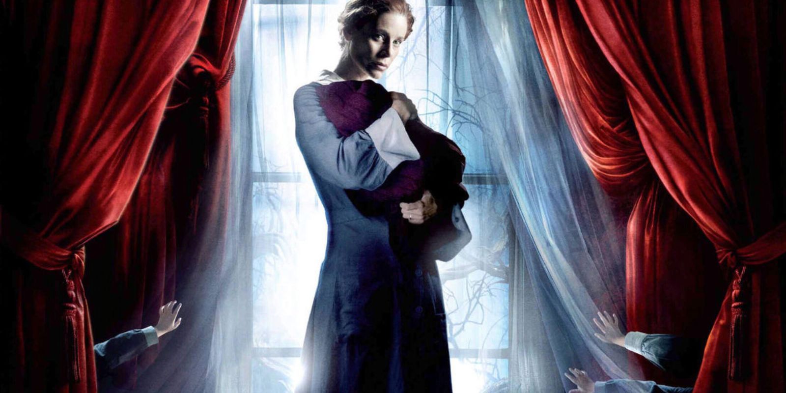 The poster for The Orphanage: a woman holds a baby while children's hands reach for them