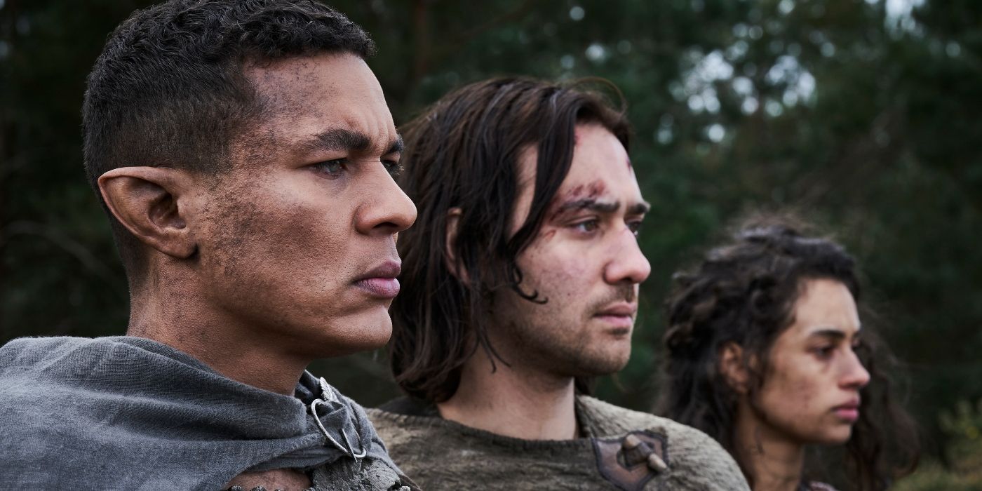 Nia Towle, Maxim Baldry, and Ismael Cruz Cordova stand together in a forest in Rings of Power Season 2