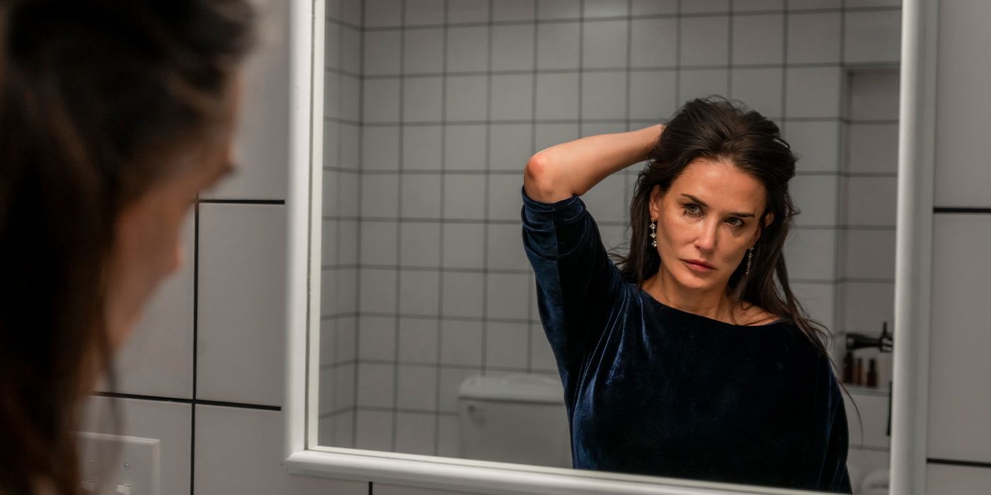 Elisabeth Sparkle, played by actor Demi Moore, stares at herself in the mirror in The Substance.