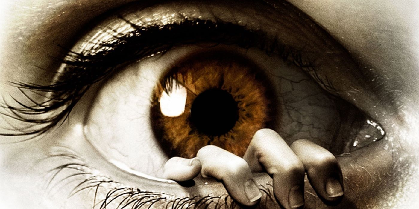 Promotional image for &lsquo;The Eye&rsquo; (2008) featuring a hand creeping out from within a lower eyelid