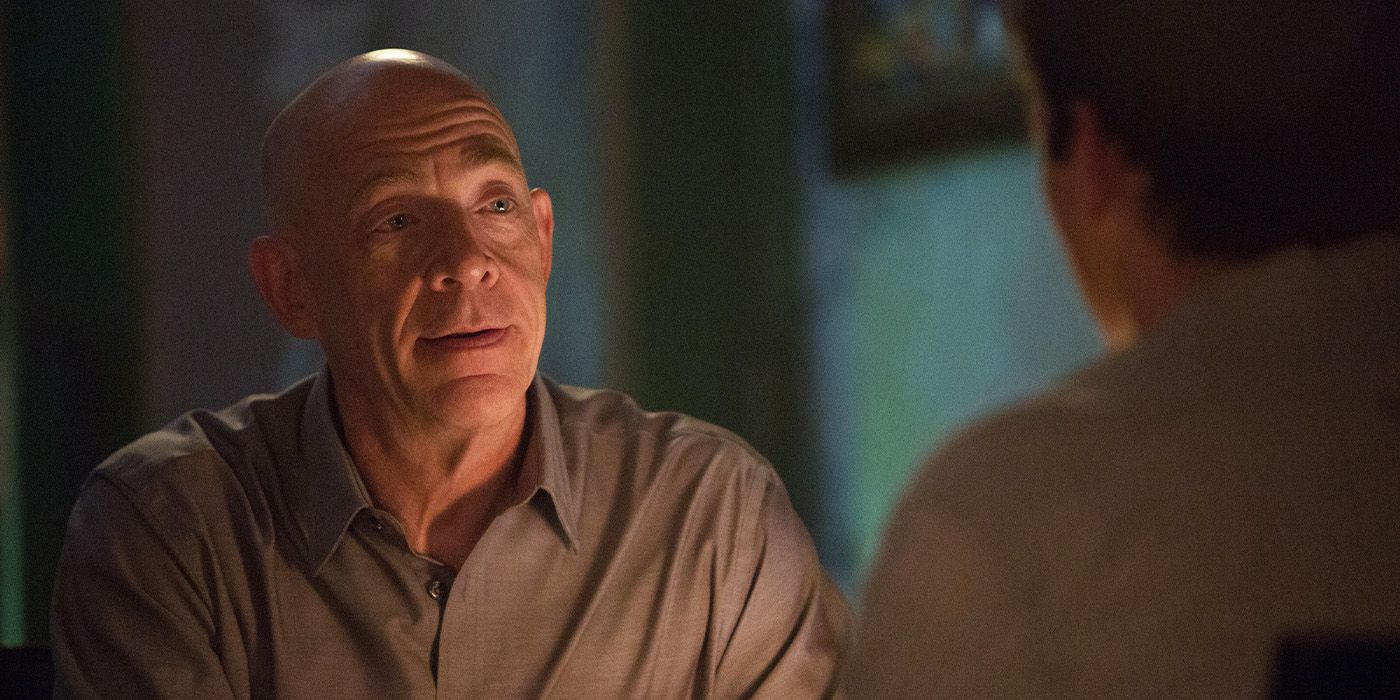 JK Simmons talking with Miles Teller in a dimly lit room