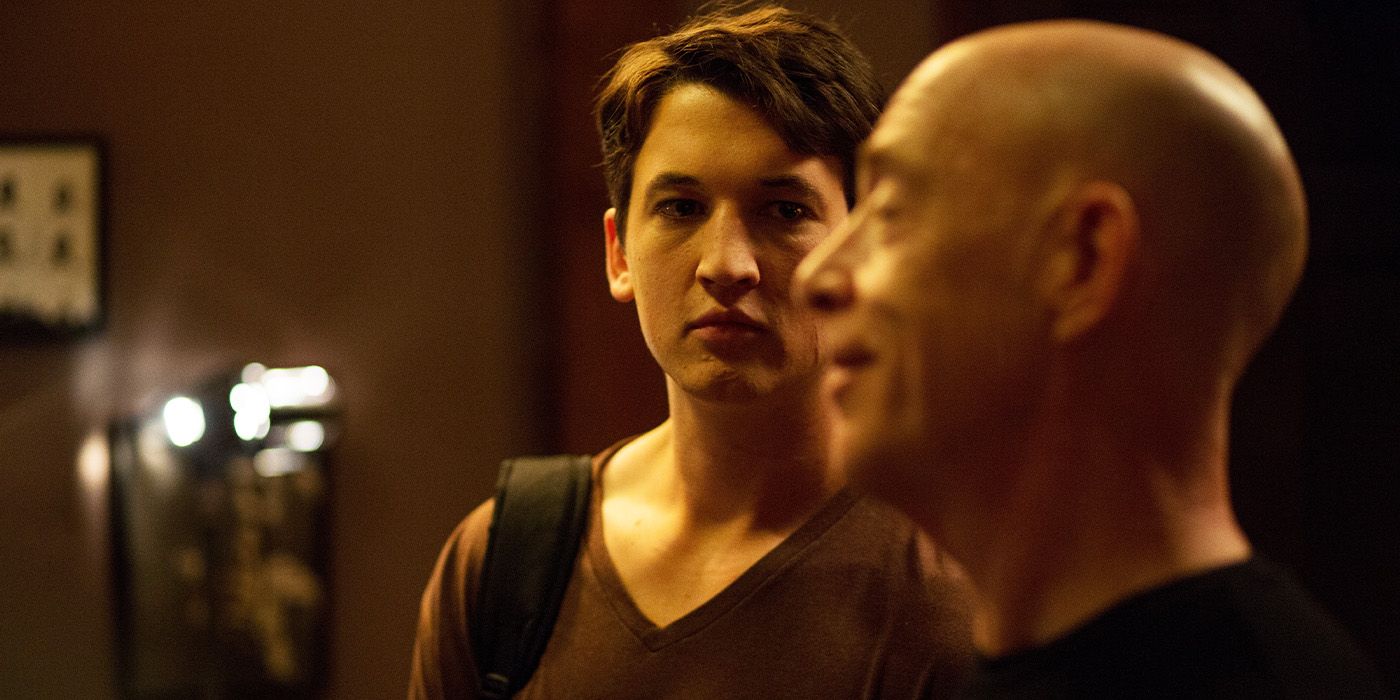 Miles Teller looking intensely at JK Simmons who's out of focus