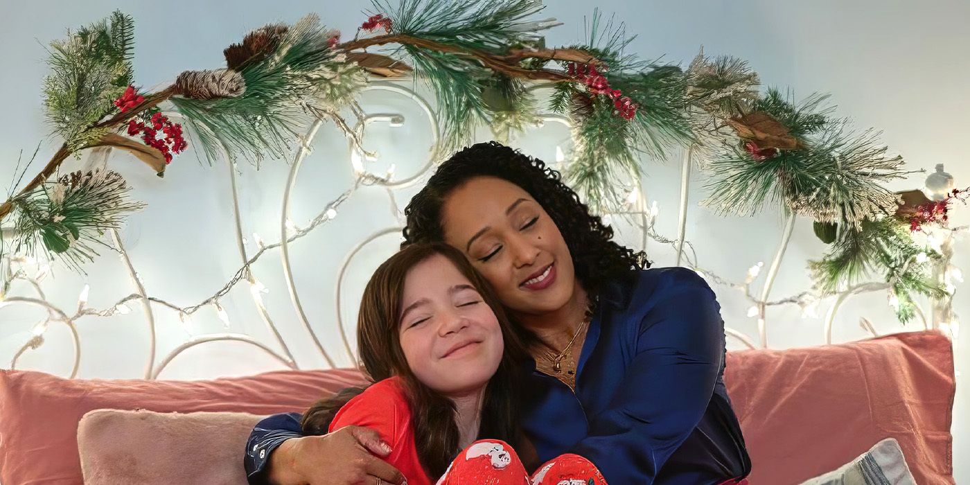 Audrey Wise Alvarez and Tamera Mowry Housley embrace in 'Scouting For Christmas'