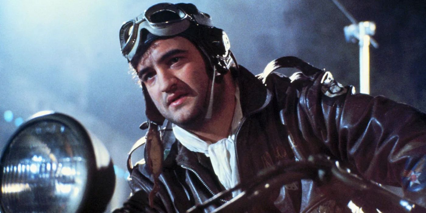 An aviator wearing a leather jacket sits on his motorbike on a cool and misty night in '1941' (1979).