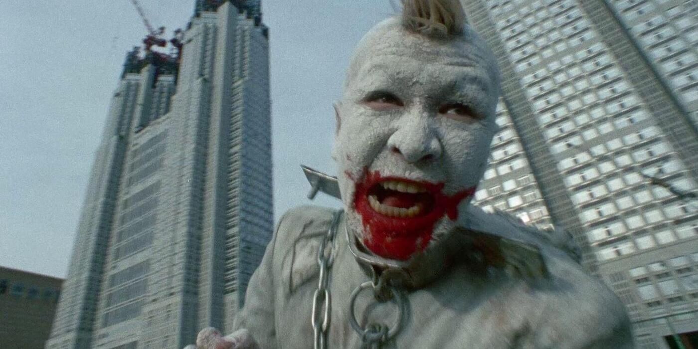 Pinocchio 964 screaming with blood around his mouth and skyscrapers being built in the background.