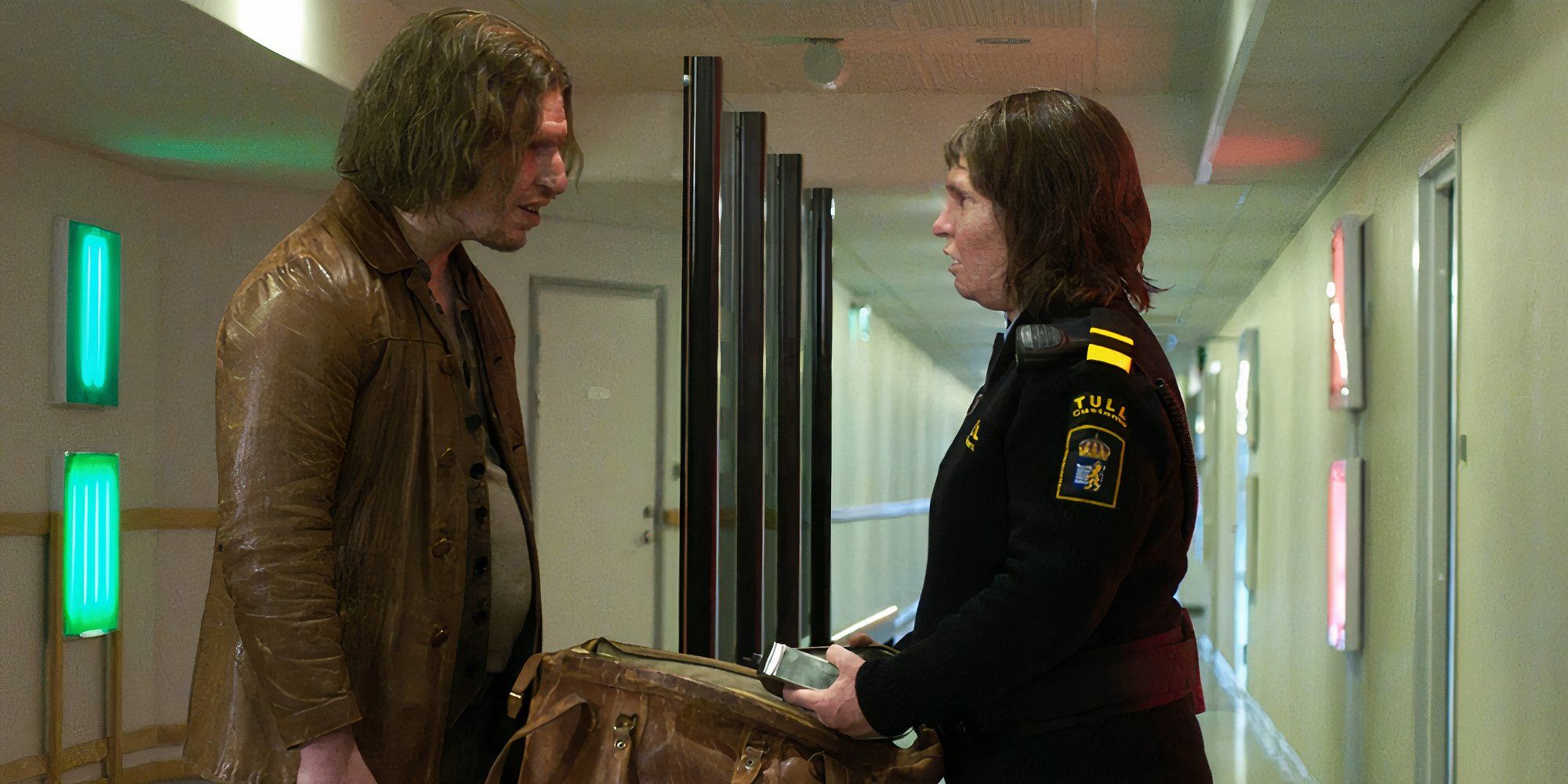 A man and a woman stand in front of each other in Border