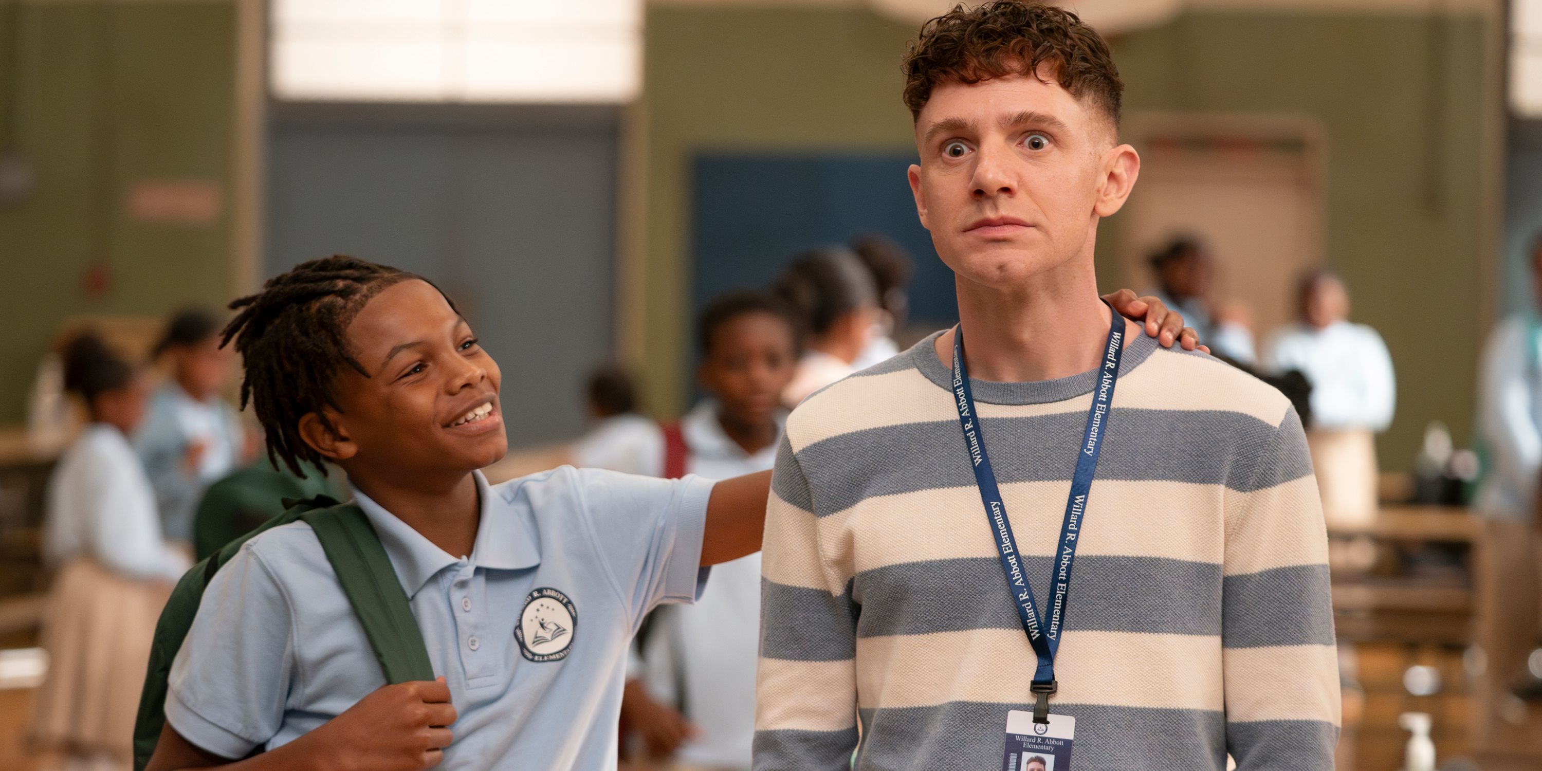 A student (Dax Rey) patting Jacob (Chris Perfetti) on the back  in Abbott Elementary Season 4, Episode 2 