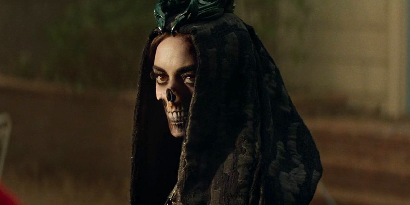 Aubrey Plaza as Death with half of a skull face with a hood on and looking at Billy in Agatha All Along.