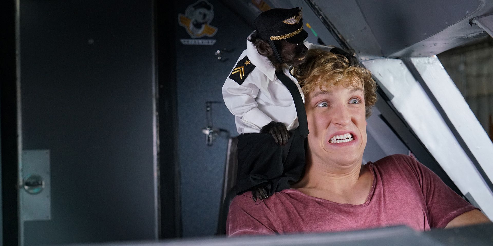 Logan Paul attempting to pilot an airplane with a monkey wearing a pilot's outfit on his shoulder in 'Airplane Mode' (2019)