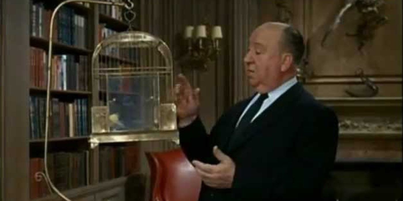Alfred Hitchcock looks at a bird cage in the trailer for &lsquo;The Birds&rsquo;