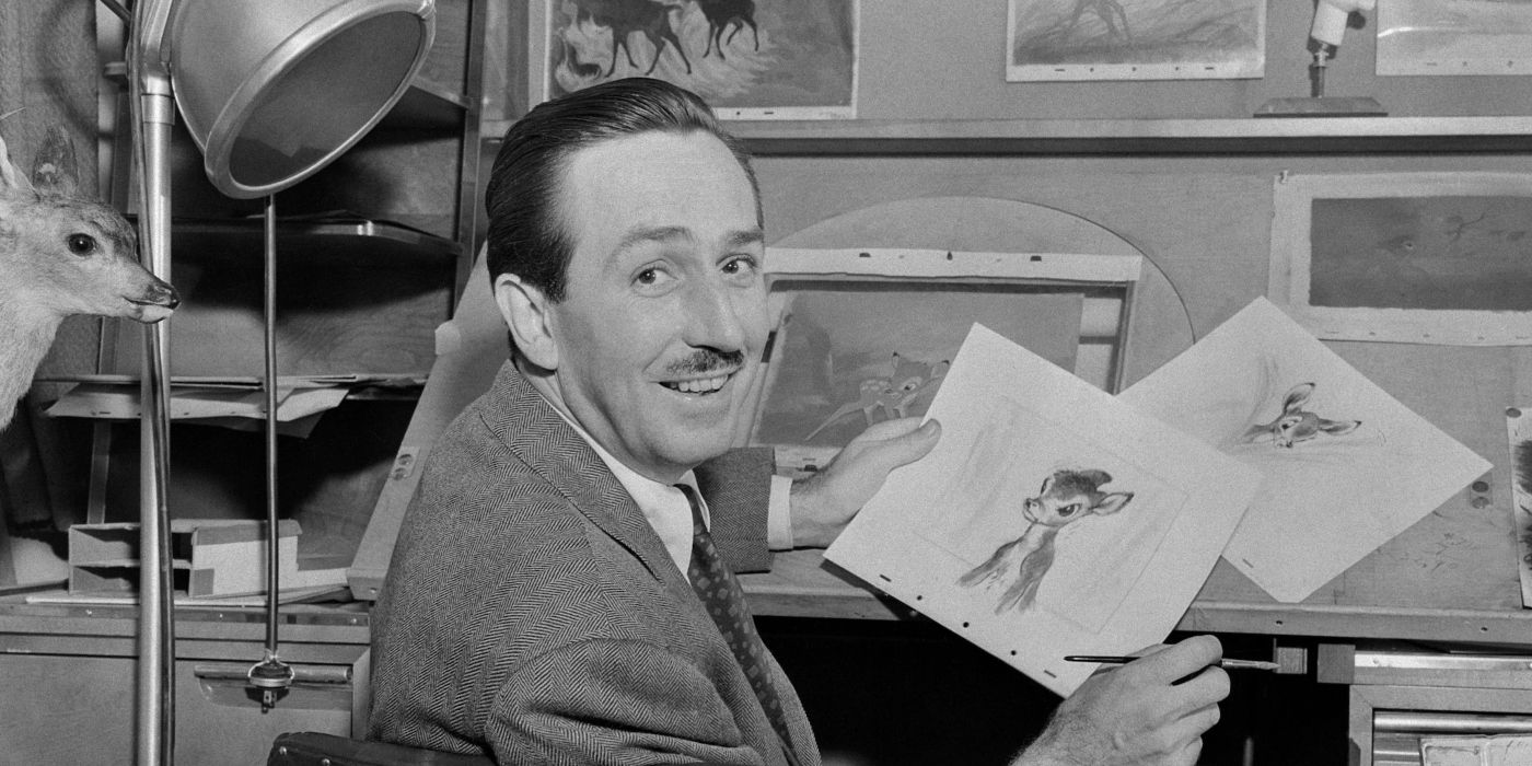 Walt Disney holding up a picture of Bambi 