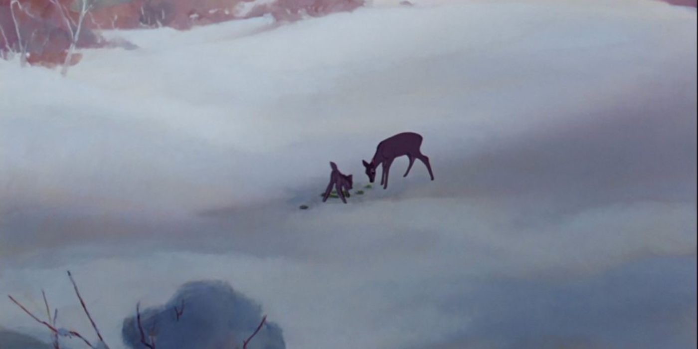 Bambi and his mother chomp on a small patch of grass amid an snowy, wintery landscape in 'Bambi' (1942).