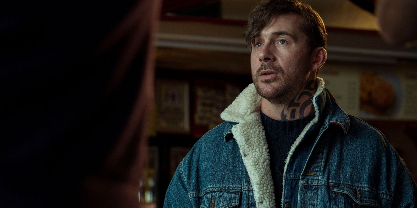 Barry Sloane wearing a denim jacket in Passenger